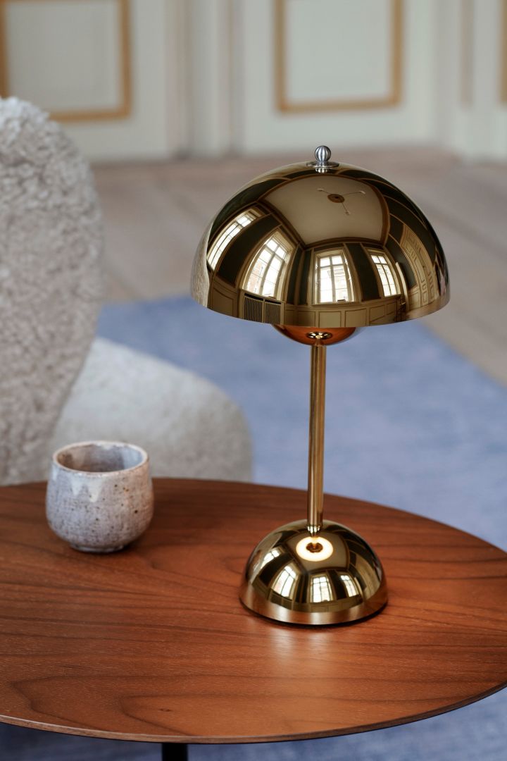 The portable lamp VP9 from &Tradition seen here in a brass finish giving your interior a luxurious finish - one of the Scandinavian interior design trends for 2023.