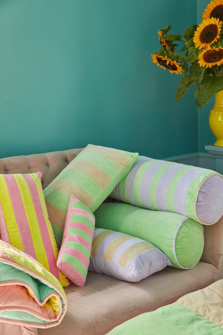 Striped, neon coloured cushions from Rice available in different shapes are one of the more playful Scandinavian interior design trends for 2023.